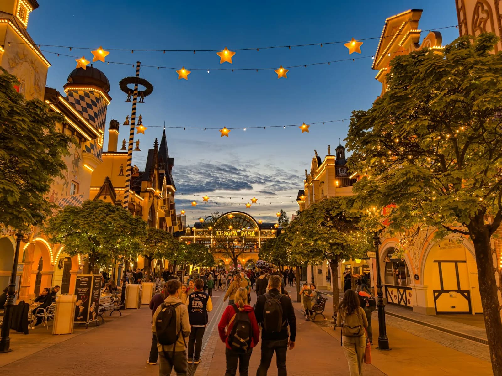 Europa-Park entrance and themed promenade lit up at twilight in Rust, Germany